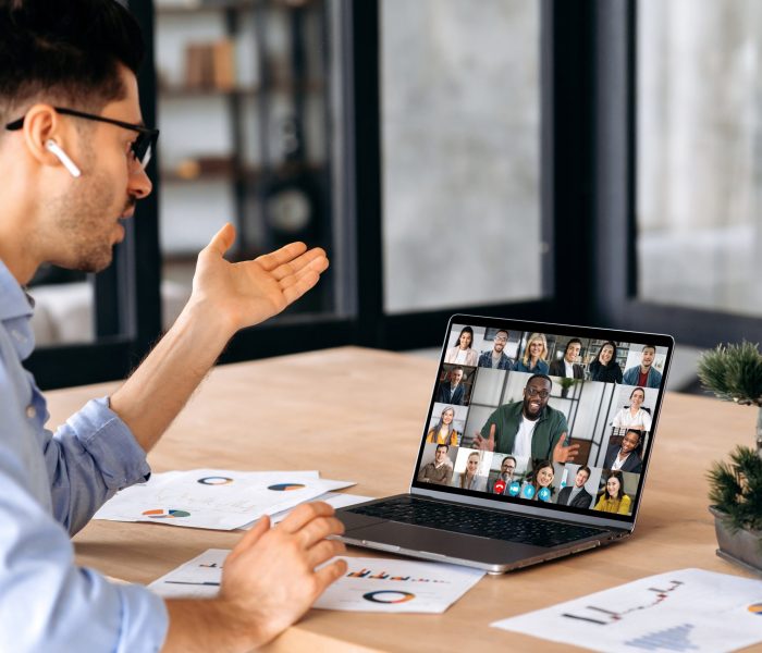 Online business meeting, brainstorm of employees. Caucasian successful man, ceo, talking on video conference call with colleagues of different nationalities, discussing the project.Online conversation